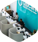 Small circular photo of Metabolic Medical Clinic front desk area with staff at white cubicles and turquoise wall with Metabolic sign